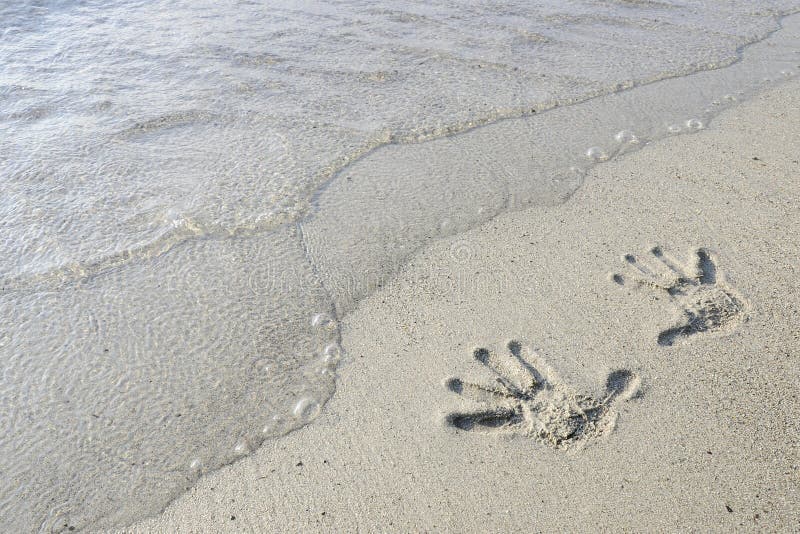 Hand prints in the sand