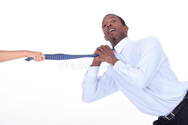 Hand pulling man's tie royalty free stock images