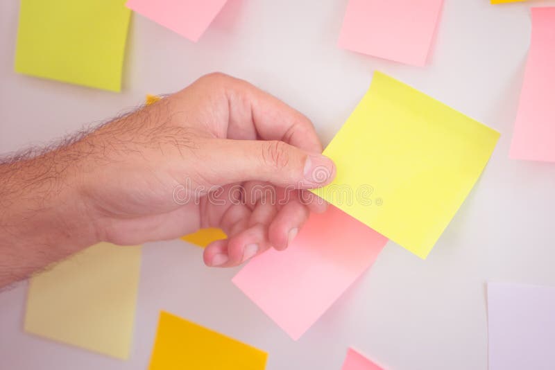 Pulling Reminder Posted Note Paper Out of the Board Stock Image Image
