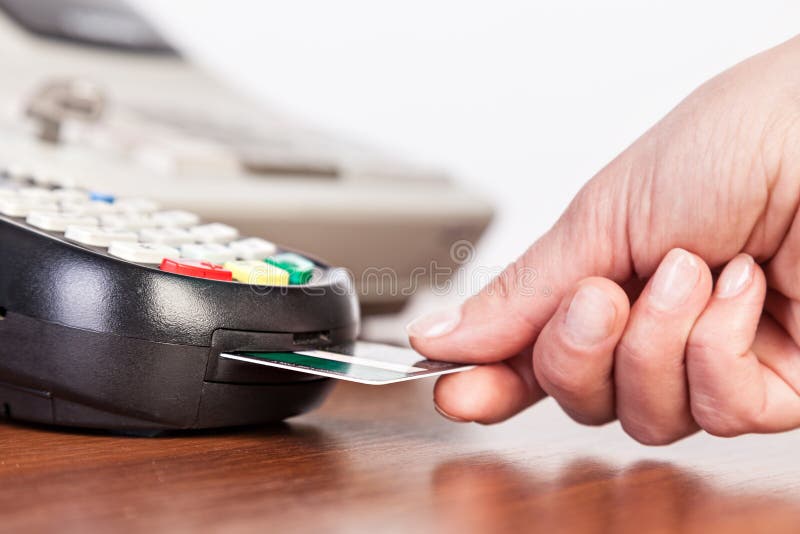Hand Push Credit Card into a Credit Card Machine. Stock Photo Image