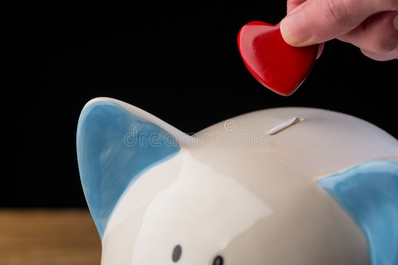 Hand Putting Heart Piggy Bank Stock Photos Free & RoyaltyFree Stock