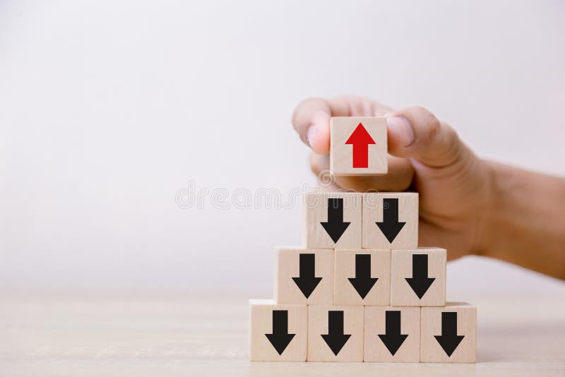 Hand putting wood cube block on top pyramid wooden blocks royalty free stock photo Hand putting wood cube block on top pyramid wooden blocks royalty free stock photo
