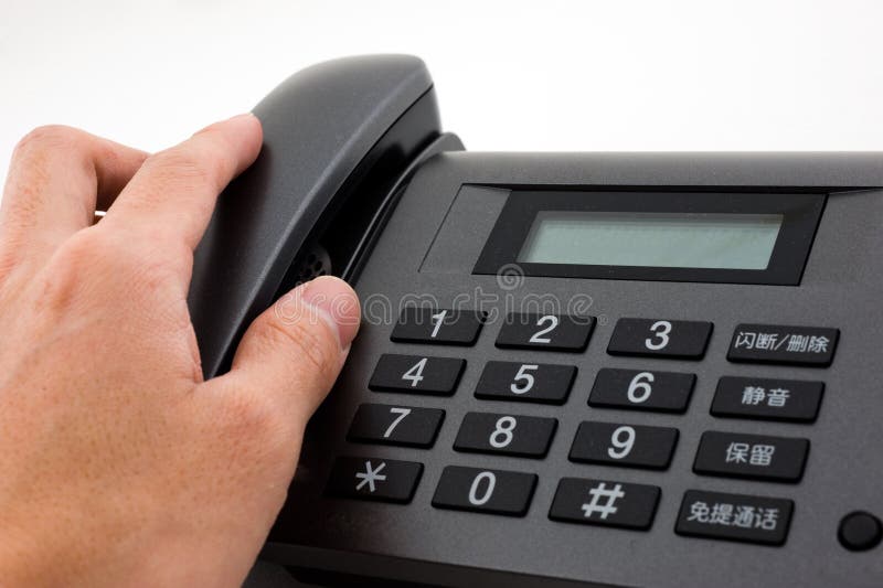 Hand reaching for telephone stock photography