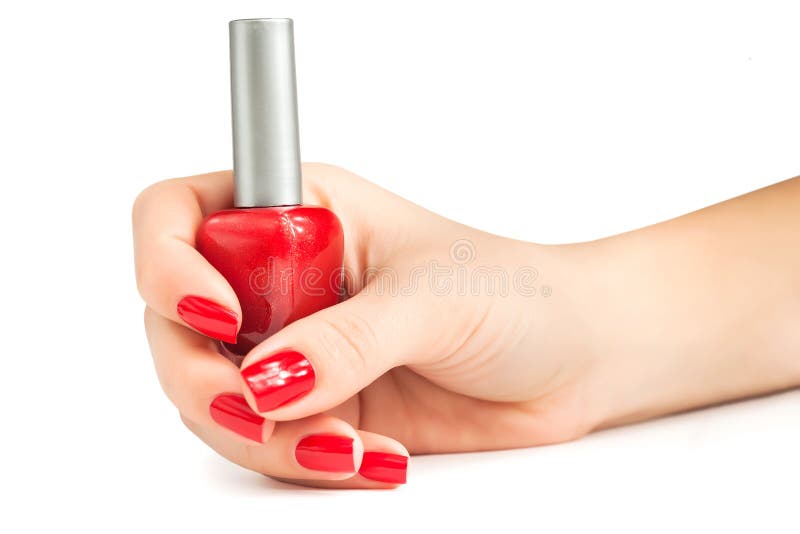 Hand with red nail polish bottle isolated royalty free stock images