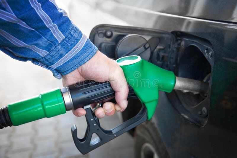 Hand Refilling the black Car with Fuel