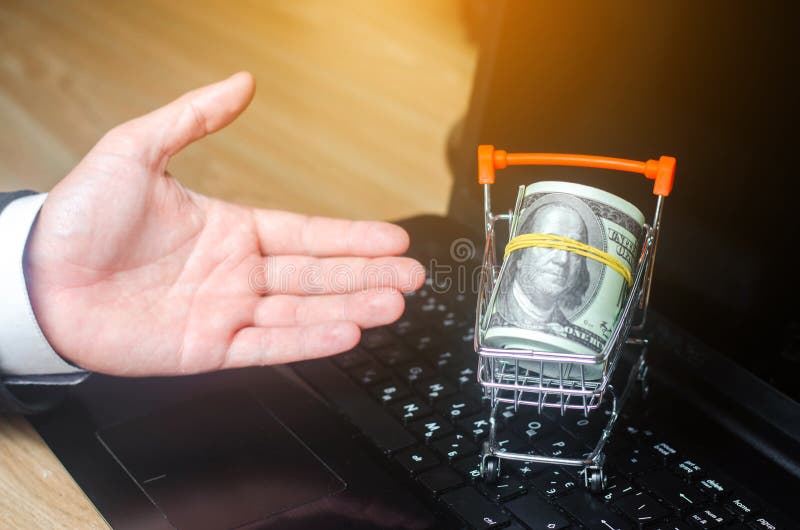 hand represents a supermarket cart on a laptop. The concept of shopping online. Place market, commerce, Internet commerce. royalty free stock photo hand represents a supermarket cart on a laptop. The concept of shopping online. Place market, commerce, Internet commerce. royalty free stock photo