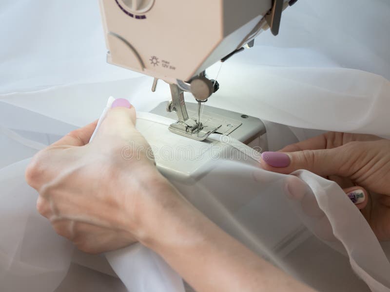 Hand Sews a Tulle on the Sewing Machine. Stock Photo Image of machine