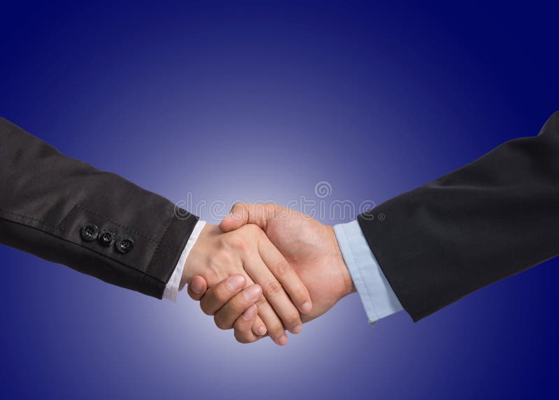 Hand shake between a businessman and a businesswoman on dark blu royalty fr...