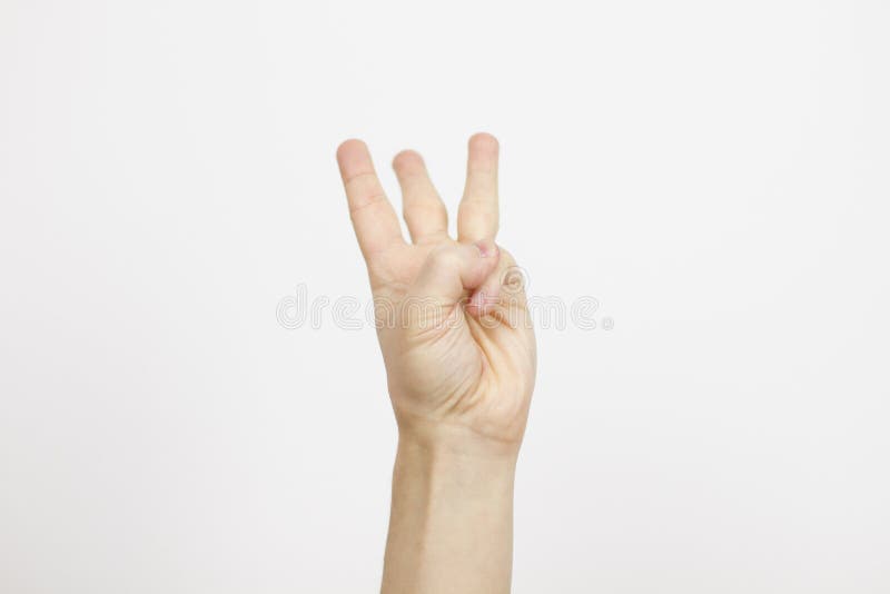 Hand is showing three fingers on white background .