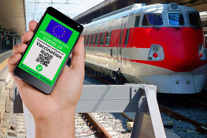 Hand showing valid european digital vaccination certificate on smartphone display at train station