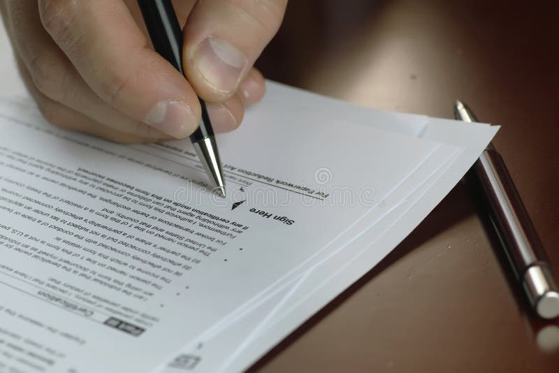 Hand signed tax form stock image Hand signed tax form stock image