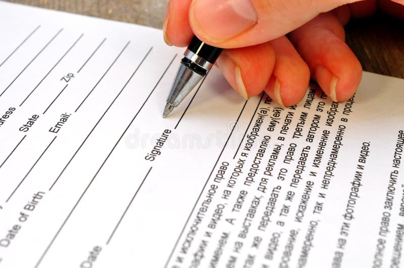 Hand signs the document stock photo