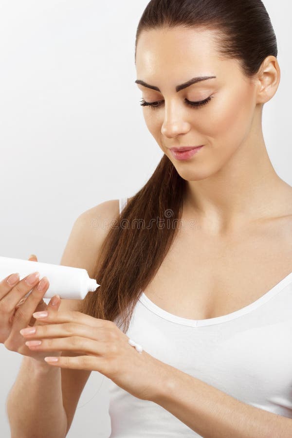 Hand Skin Care. Close Up Of Female Hands Applying Cream, Lotion. Beautiful Woman Hands With Red Manicure. Nails Applying Cosmetic