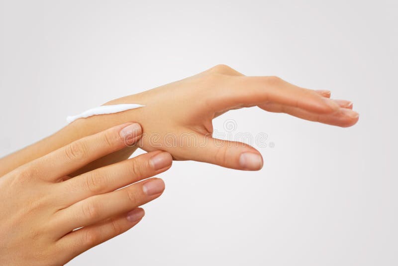 Hand Skin Care. Close Up Of Female Hands Applying Cream, Lotion. Beautiful Woman Hands With Red Manicure