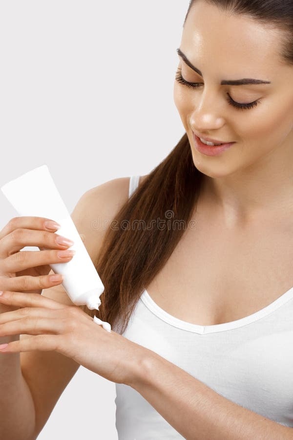 Hand Skin Care. Close Up Of Female Hands Holding Cream Tube, Beautiful Woman Hands With Natural Manicure Nails Applying Cosmetic