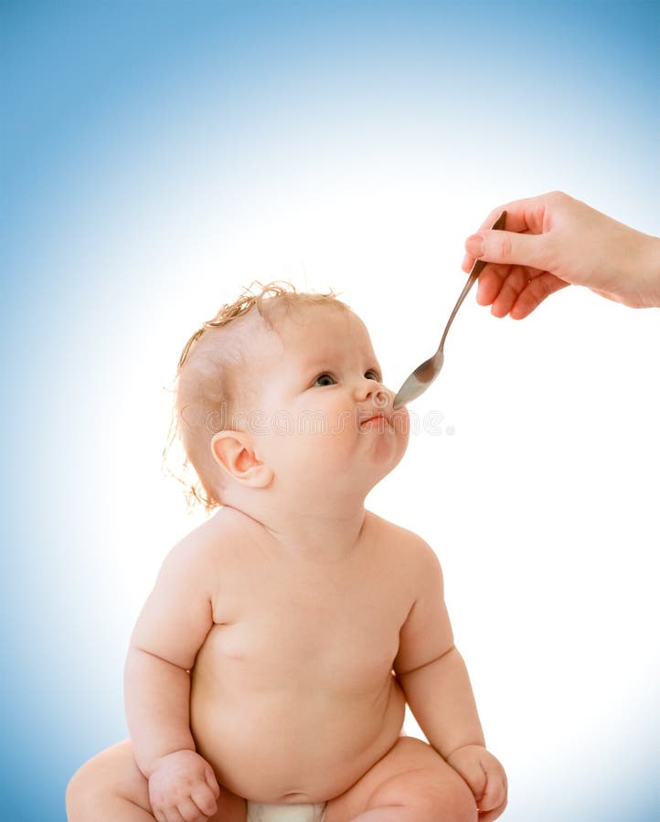 Hand with spoon little baby feeding