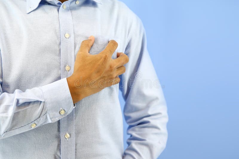 Hand Squeezing the Left Chest Pain on Blue Background Concept of Heart
