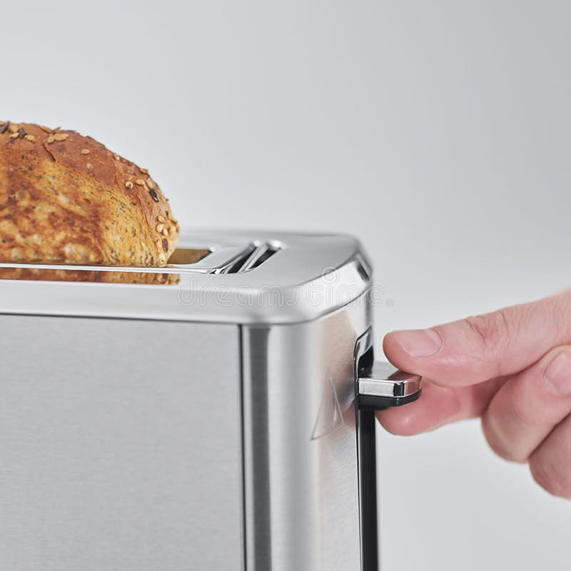 A Woman In The Kitchen Spreads Butter On Toast, A Toaster In The Kitchen Heats The Croissant