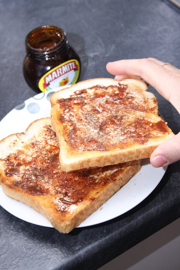 hand-takes-piece-marmite-toast-photographing-showing-two-pieces-taking-one-179968791.jpg