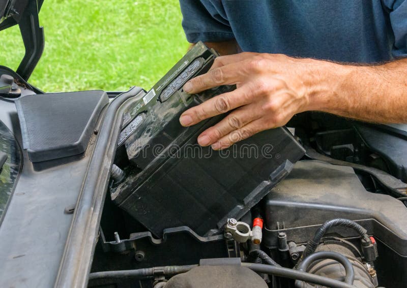 Removing a Car Battery from a Tight Engine Location Stock Photo Image