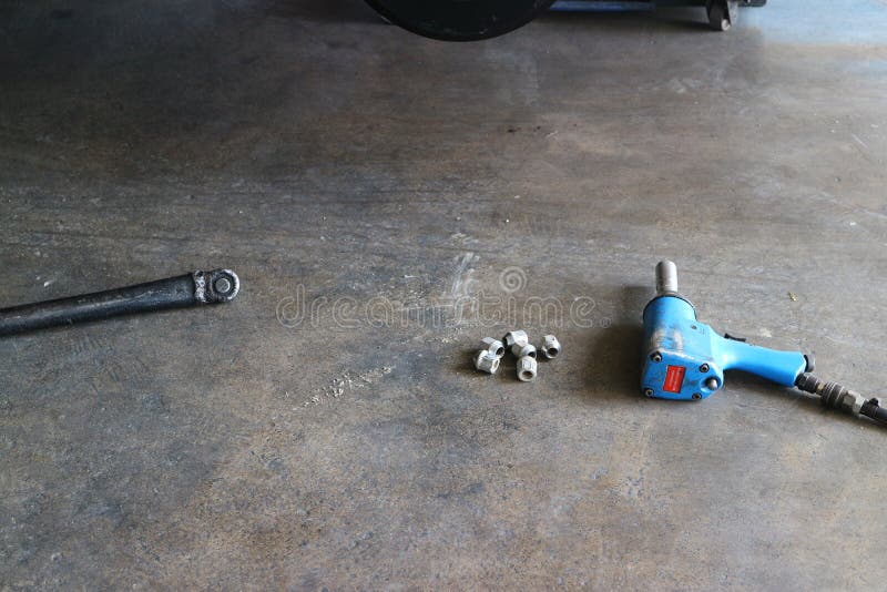 Hand Tools for Removing Car Wheels are Placed on the Floor in an Empty