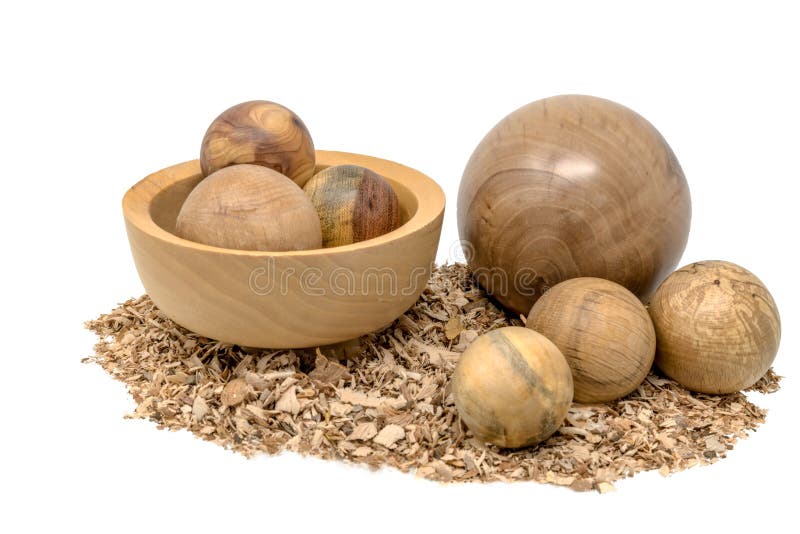 Hand-turned wooden balls in a bowl decorated with sawdust