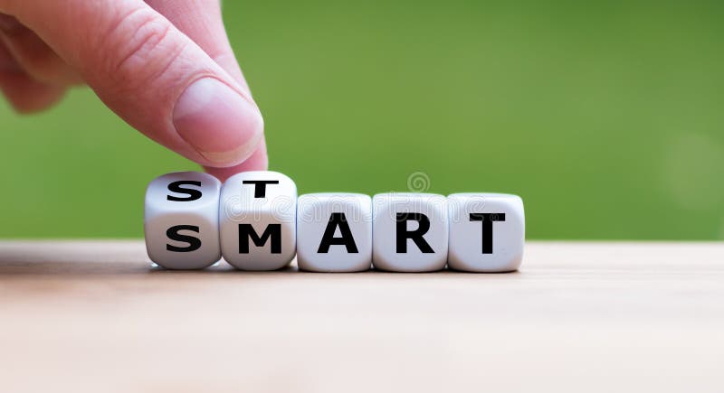 Hand turns dice and changes the word `start` to `smart`. royalty free stock image Hand turns dice and changes the word `start` to `smart`. royalty free stock image
