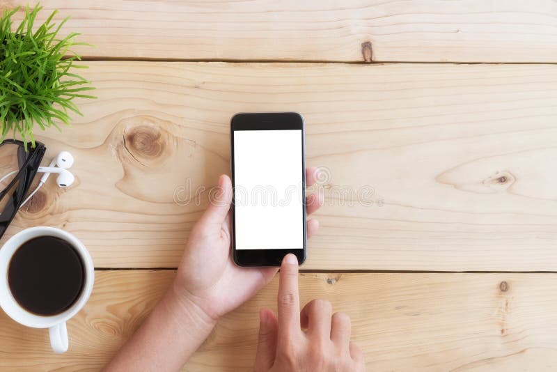 Hand use phone on wood table. Hand use phone white screen on wood table. Male hand holding businessman stock images, royalty-free photos and pictures