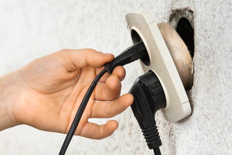 Hand using broken old electric socket stock photography Hand using broken old electric socket stock photography