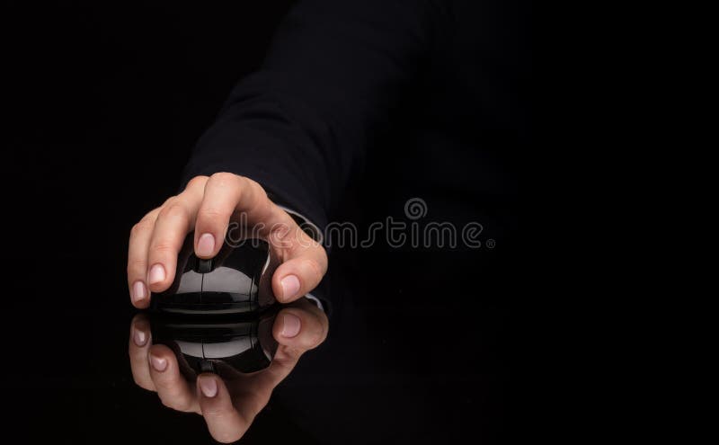 Hand using mouse on dark background stock photo