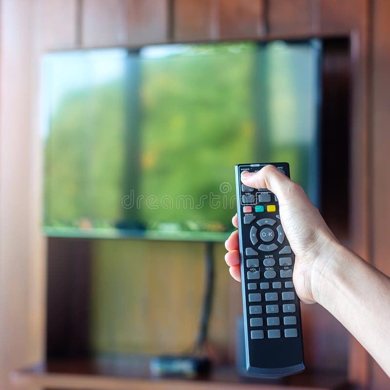 Hand Using Remote Controller for Adjust Smart TV Inside the Modern Room