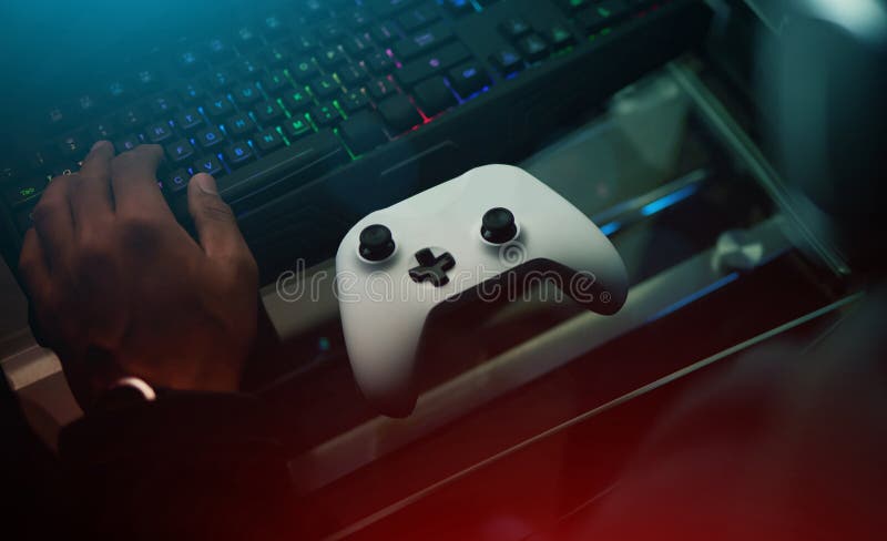 Gamer using controller to play online video games on computer. Man playing  game with joystick and headphones in front of monitor. Player having gaming  equipment, doing fun activity Stock Photo - Alamy