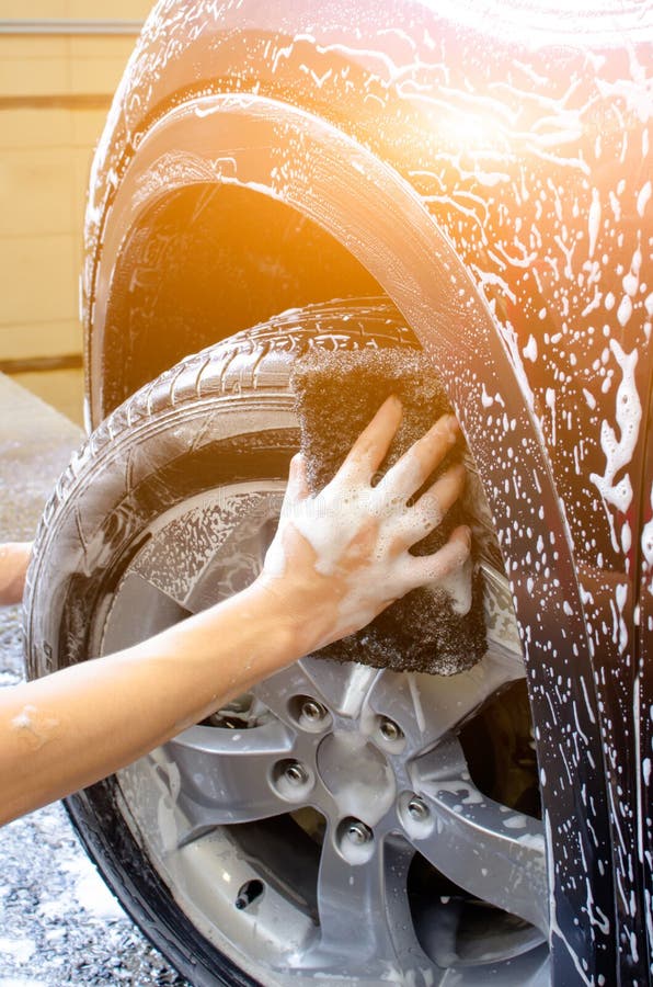 Hand Washing Car Surface with Bubble Foam and Micro Fiber Cloth Stock