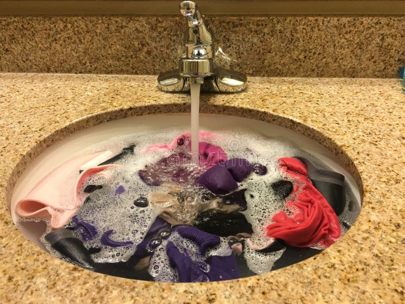 Hand Laundry Worker In The Process Of Removing Stains By Using A