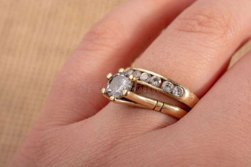 Hand wearing a diamond ring on a textured background stock images Hand wearing a diamond ring on a textured background stock images