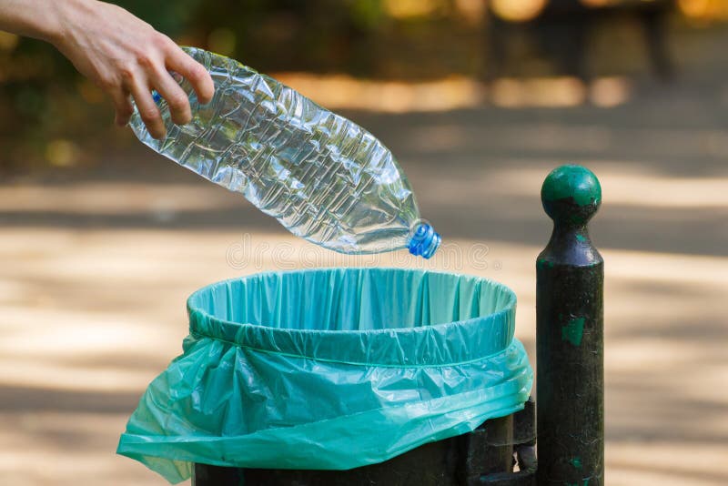 Hand Of Woman Throwing Plastic Bottle Into Recycling Bin ...