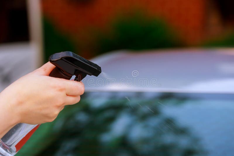 outdoor with hand of a woman washes the car