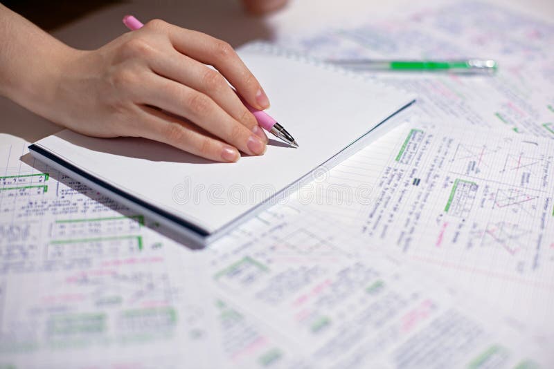 Female Hand Writes With A Pen On A Blank Sheet Of Notepad