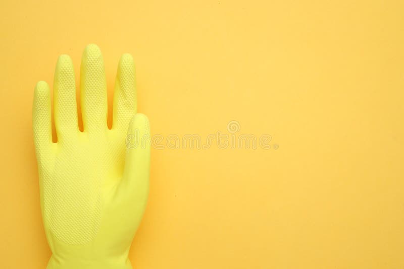 Hand in yellow glove isolated on yellow background,top view,Copy space for the ads