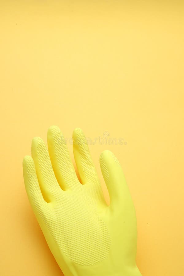 Hand in yellow glove isolated on yellow background,top view,Copy space for the ads