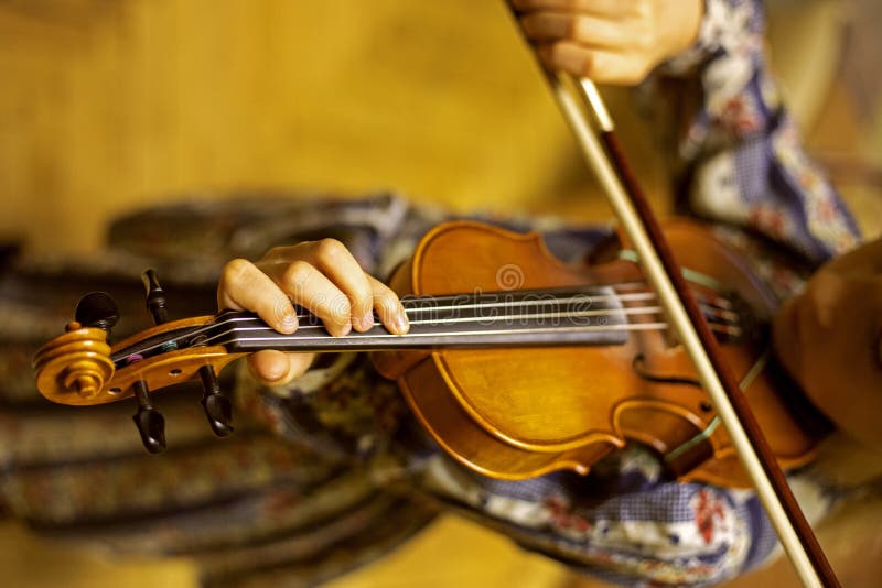 Hand of a Young Violinist Holding the Neck and Pressing the Strings