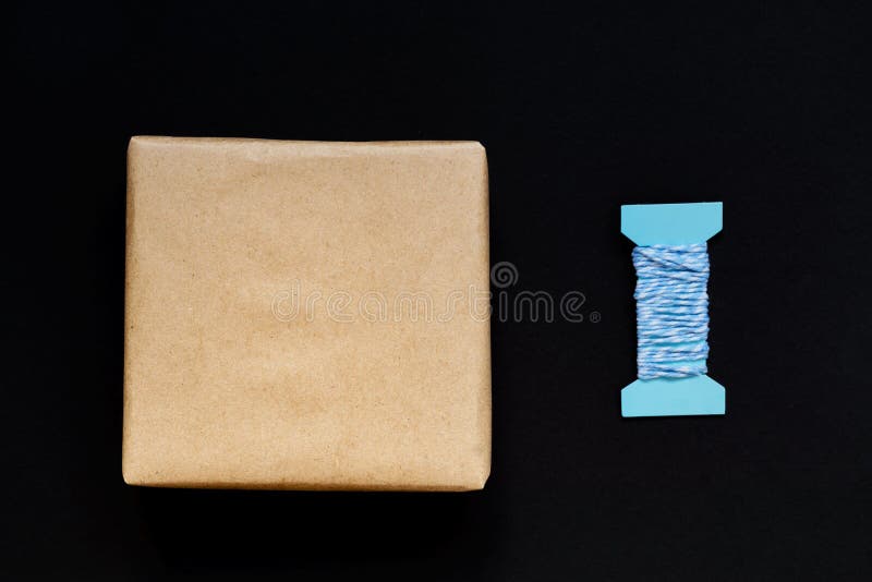 Handcrafted gift box wrapped in Craft paper with blue ribbon and bow stock photo Handcrafted gift box wrapped in Craft paper with blue ribbon and bow stock photo