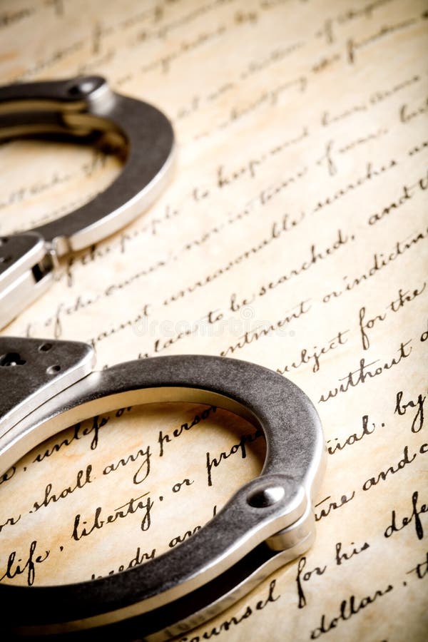 Handcuffs on constitution stock image Handcuffs on constitution stock image