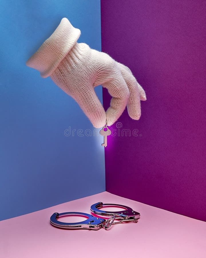 Handcuffs. a Hand in a White Glove Holds the Handcuff Keys Stock Photo