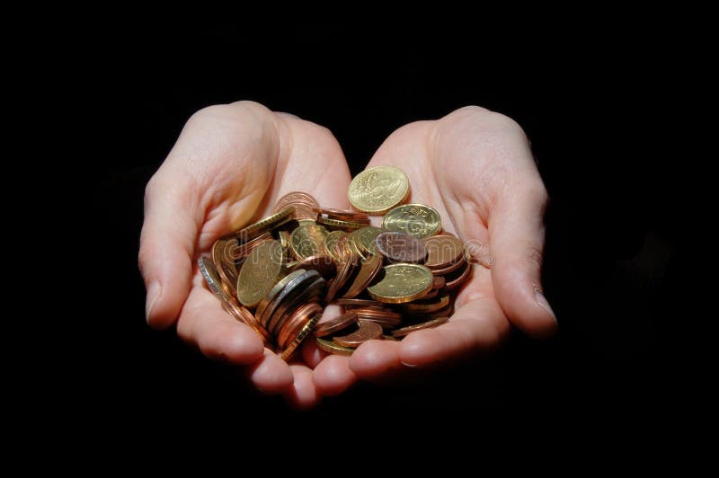 Hands with money coins on a black background. Hands with money coins on a black background