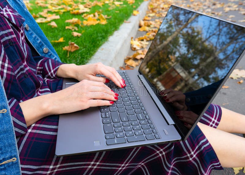 Handen van een jong meisje met een laptop in het park Mooie manicure Autumn Park stock fotografie Handen van een jong meisje met een laptop in het park Mooie manicure Autumn Park stock fotografie