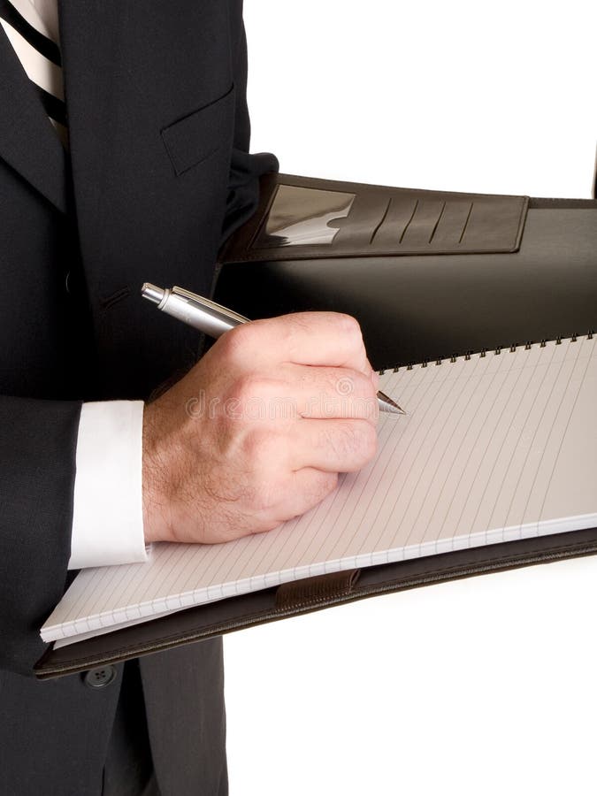 Stock photo of a well dressed businessman taking notes in a notebook. Stock photo of a well dressed businessman taking notes in a notebook.