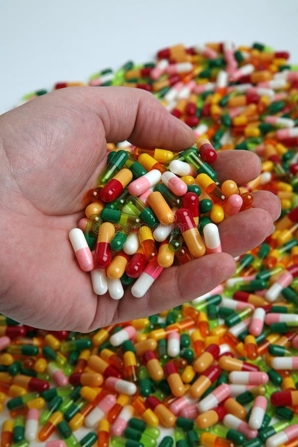 Handful of pills capsules in hand