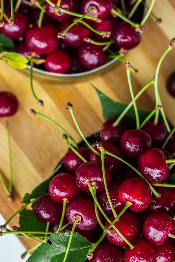 A Handful Of Ripe Red Cherries In A Metal Can On A White Background