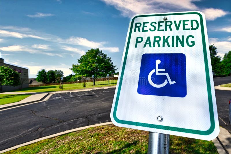 Handicap Reserved Parking Sign in Lot - Wheelchair Accessible - Blue Skies, Grass, Trees